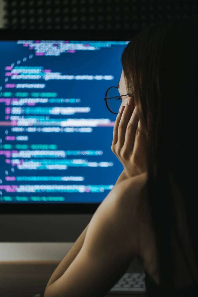 Woman working on computer code.